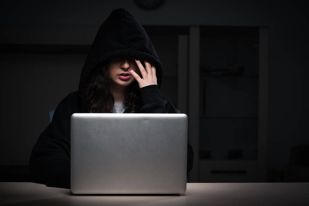 Female hacker hacking security firewall late in office - Photo, image