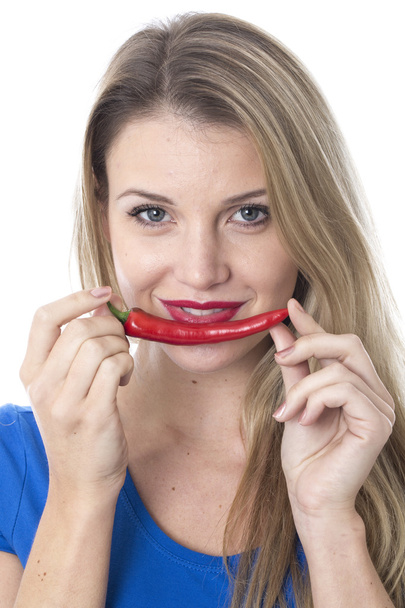 Young Woman Holding a Red Chilli Pepper - Foto, imagen