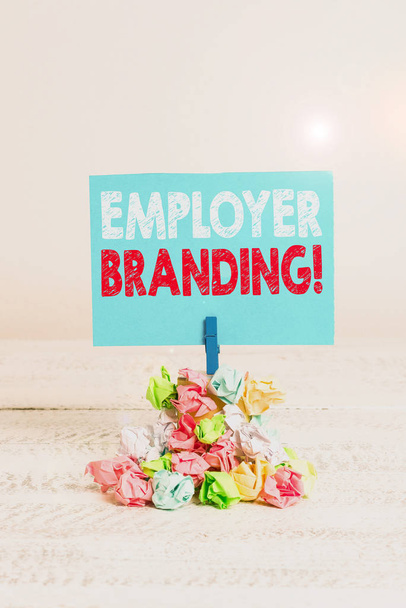 Writing note showing Employer Branding. Business photo showcasing promoting company employer choice to desired target group Reminder pile colored crumpled paper clothespin wooden space. - Photo, Image