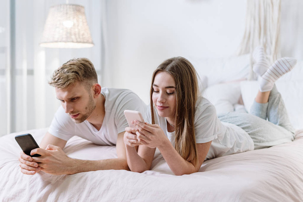 Young adult boyfriend and girlfriend spending morning at home - Photo, Image