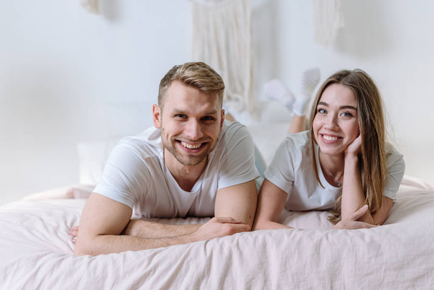 Young adult girl and guy spending weekend at home - Фото, изображение