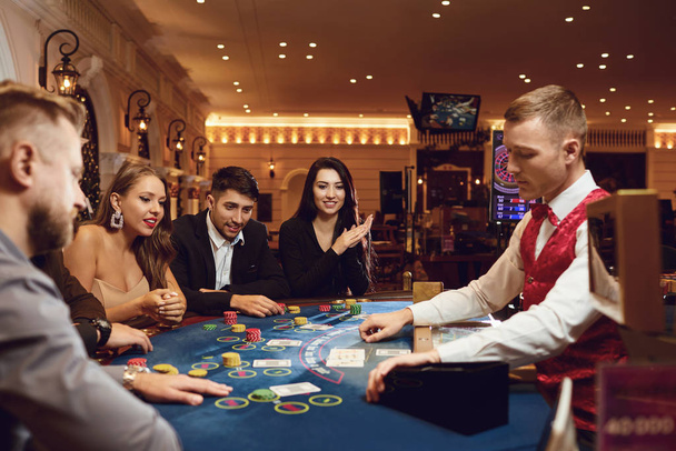 People gamble at a poker table in a casino - Fotó, kép