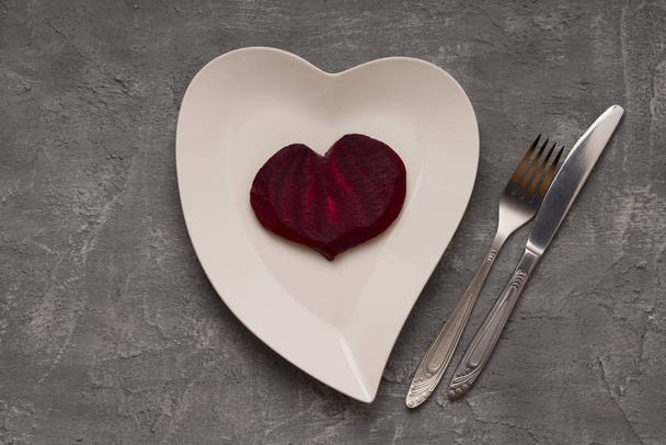 Plate with red heart and fork on concrete table. Valentines Day  - Fotografie, Obrázek