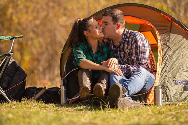 Couple in love kissing in front of the tent - 写真・画像