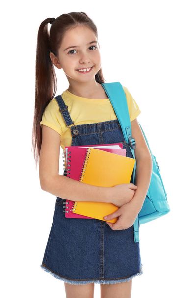 Little girl with school stationery on white background - Foto, Imagen