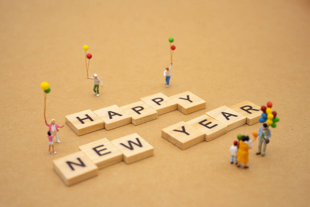 Family Miniature people standing with wood word Happy new year u - Photo, Image