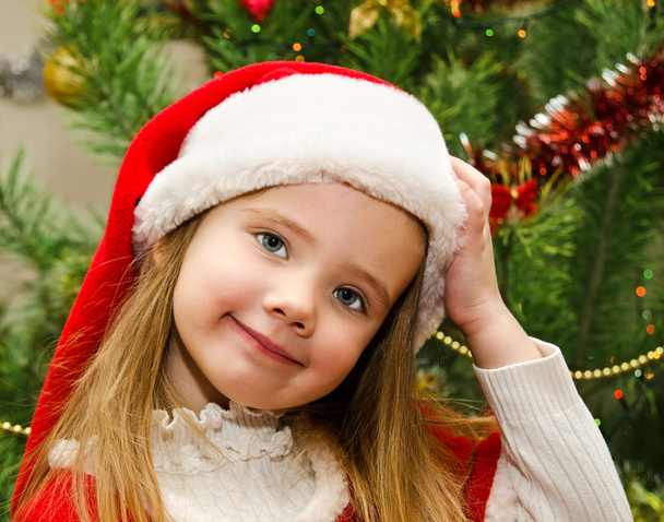 little girl in santa hat with present have a christmas - Fotoğraf, Görsel