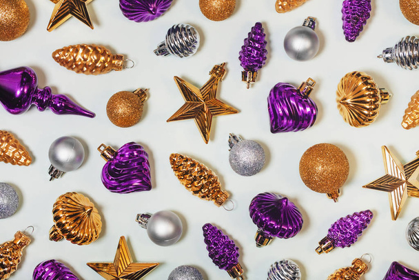 Retro Xmas ornaments decorative background. Vintage Christmas tree toys, festive decorations. Silver, golden and purple baubles, cones, stars. New Year horizontal backdrop for card. - Zdjęcie, obraz