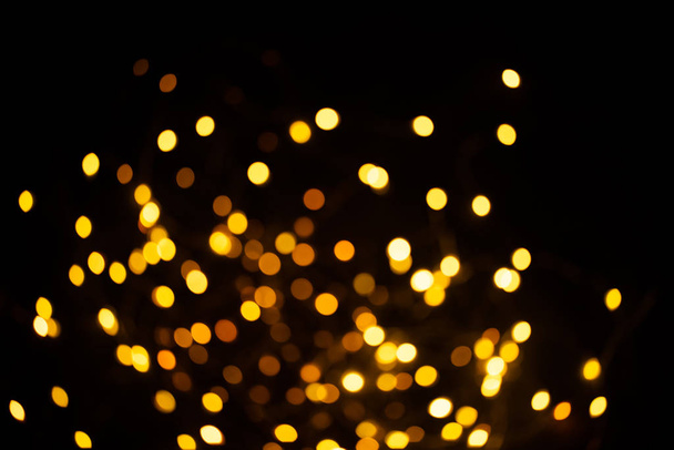 Golden sparkles raster festive background. Bokeh lights with bright shiny effect illustration. Overlapping glowing and twinkling spots decorative backdrop. Abstract glittering circles. - Фото, изображение