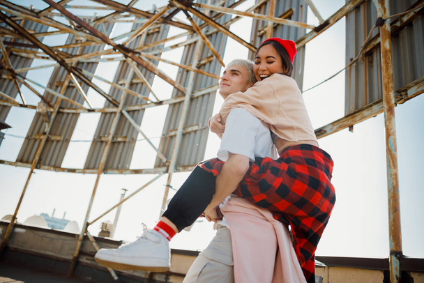 Happy pretty lady hugging her boyfriend on roof - Valokuva, kuva