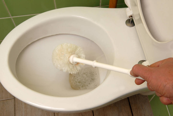 W-C cleaning with white plastic toilet brush close up - Photo, Image