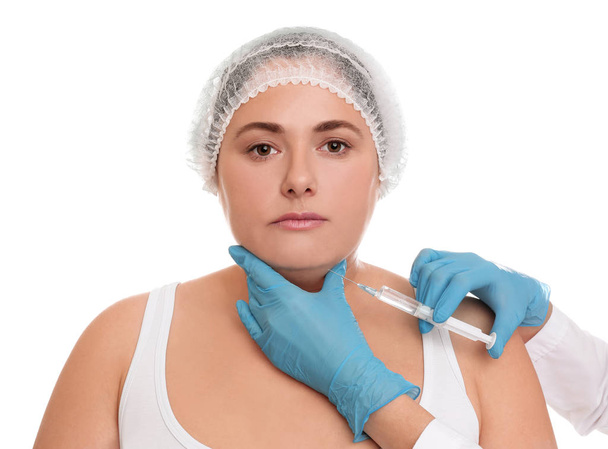 Woman with double chin getting injection on white background. Co - Fotó, kép