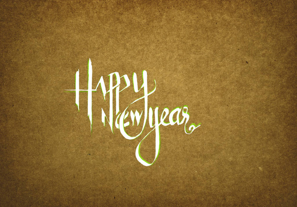 Happy New year Text - Hand written and Painted - on Khaki-Brown textured  paper background - Photo, Image