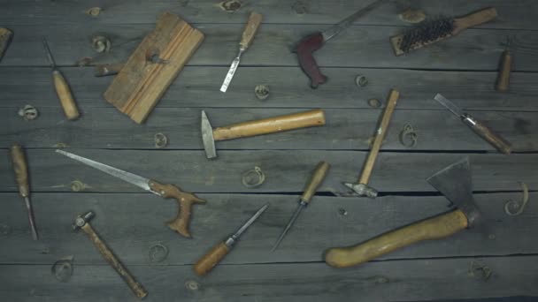 Old hand tools. Top view.On the table are mixed work tools (screwdrivers, chisels, hand saw, hammers, ax, awl, metal brush, jointer) of the 60s, 70s, 80s with wooden handles.The camera moves from right to left. - Footage, Video