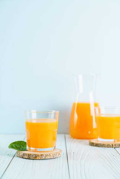 Fresh orange juice on wood background - Fotoğraf, Görsel