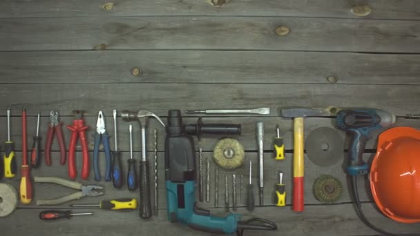 A variety of electro and hand tools. Top view.On the table are tools for various types of construction and repair work on wood, metal, concrete, plastic and other materials. The camera moves from left to right. - Footage, Video