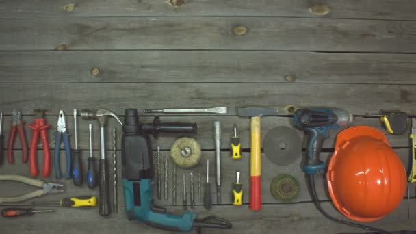 A variety of electro and hand tools. Top view. On the table are tools for various types of construction and repair work on wood, metal, concrete, plastic and other materials. The camera moves from right to left. - Footage, Video