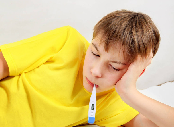 Sick Boy with a Thermometer - 写真・画像