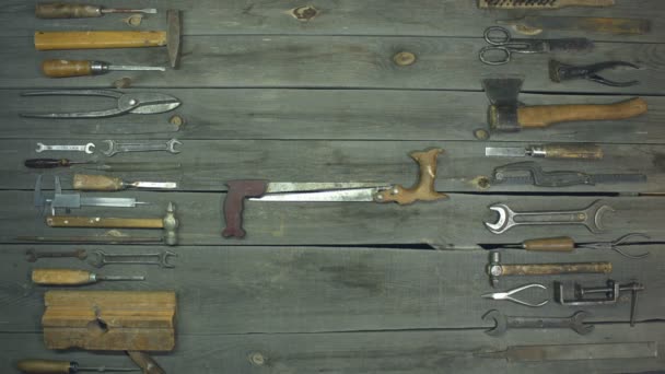 Tools for wood and metal. Stop-motion animation. Top view.Two hacksaws move apart on different sides forming a place for text.On the table are various metalwork and carpentry tools for processing wood and metal. - Footage, Video