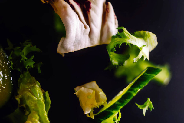 Salad levitate in air. Fresh healthy food. Vegetarian food. Plant meal - Photo, Image