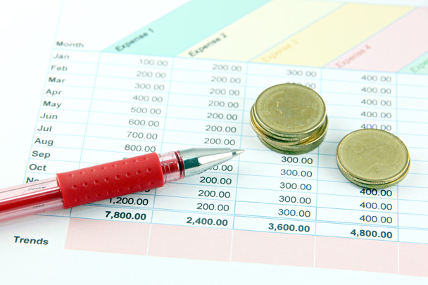 Red Pen and money Coins on the Business graph. - Photo, Image