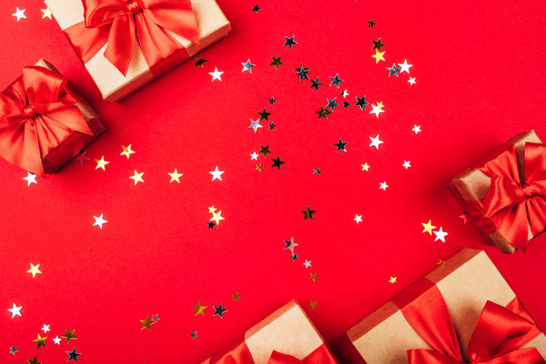 Several gift boxes with bows on a red background. - Photo, Image