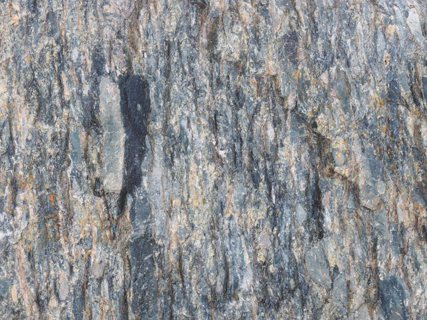 Background from black, gray, yellow old gray stone. Caucasus - Zdjęcie, obraz