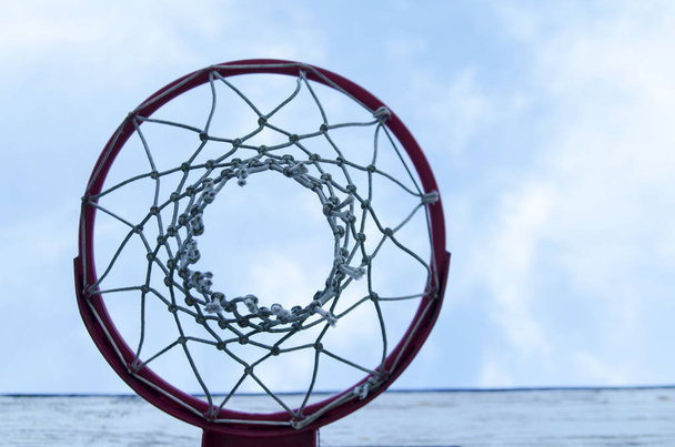 Basketball hoop outdoor photo from bellow. Blue sky background with copy paste. - Photo, Image
