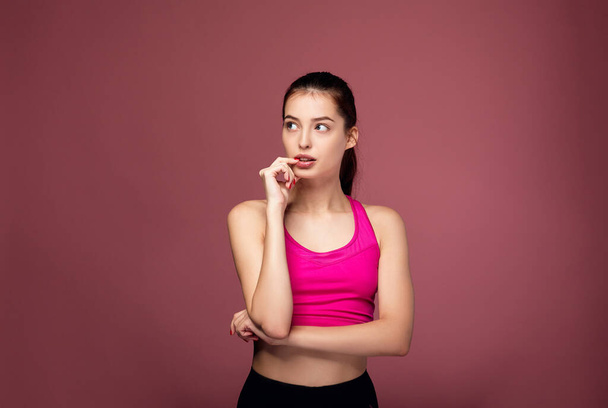 Portrait of fitness girl on the pink background. - Foto, imagen