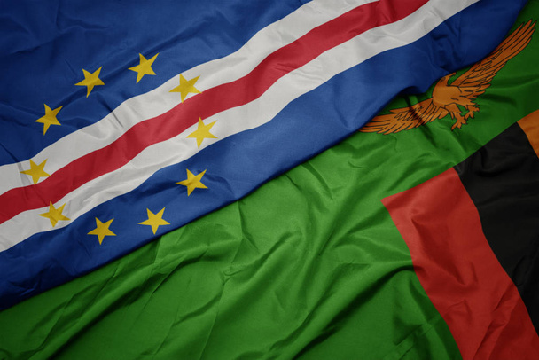 хвилястий барвистий прапор Замбії і національний прапор мису Верде
. - Фото, зображення