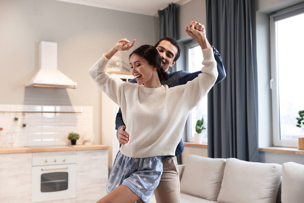 Lovely young interracial couple dancing at home - Valokuva, kuva