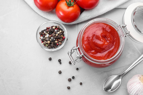 Flat lay composition with tomato sauce on light grey table - Φωτογραφία, εικόνα