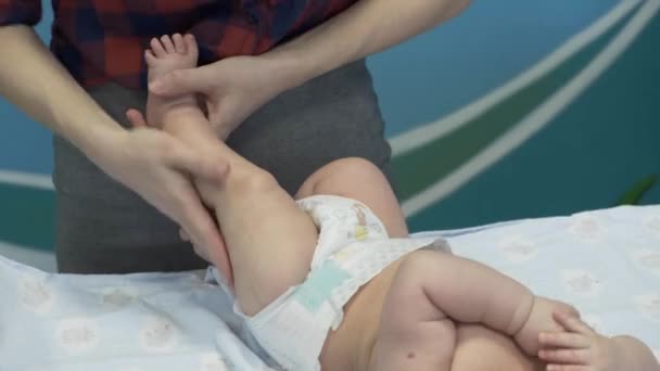 mother strokes her newborn baby's feet - Filmati, video