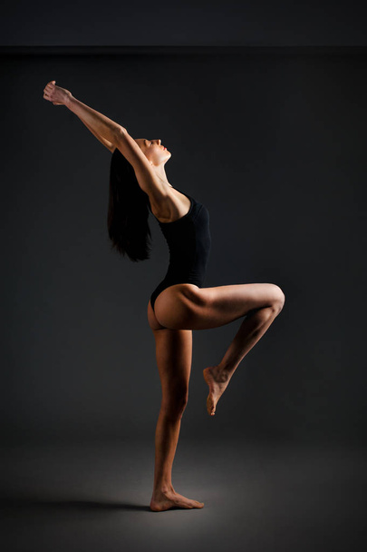 theatrically photo with oriental exterior slim girl shows yoga poses - Photo, Image