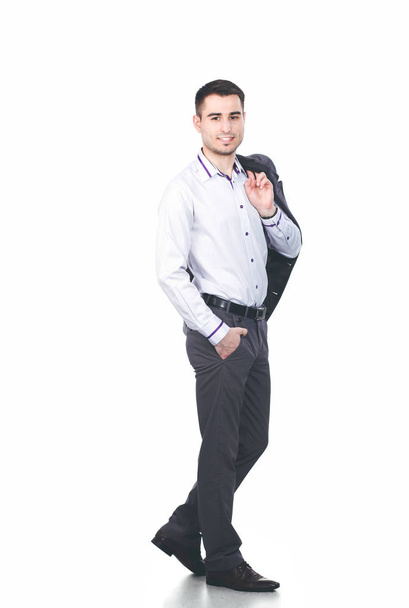 Standing man smiling while crossing his arms and against white background - Foto, imagen