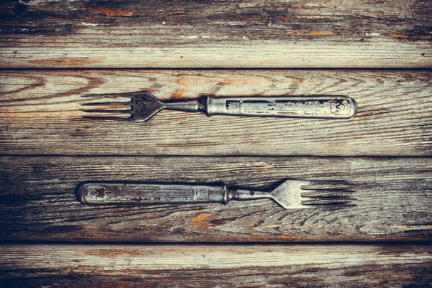 Antique metal rusty fork on a vintage surface - Foto, Imagen