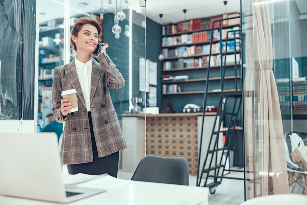 Happy woman with cellphone and coffee stock photo - Foto, immagini