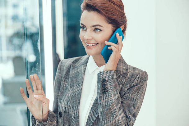 Pleasant phone talk in the office stock photo - Photo, image