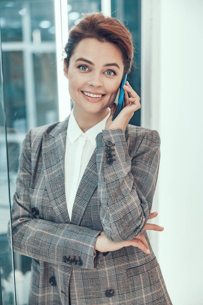 Beautiful smiling woman with cellphone stock photo - Foto, immagini