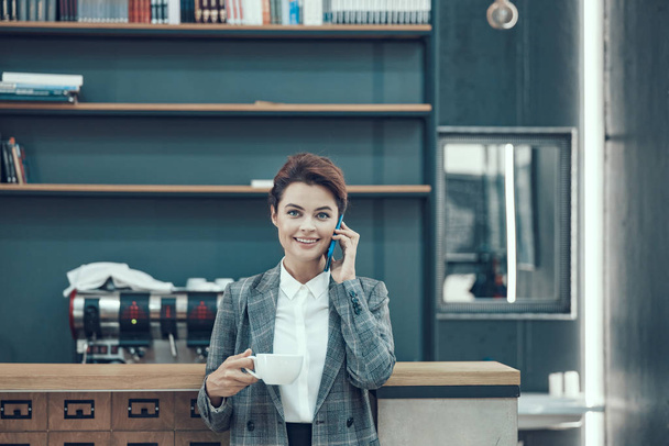 Confident boss with cellphone and coffee stock photo - Photo, Image