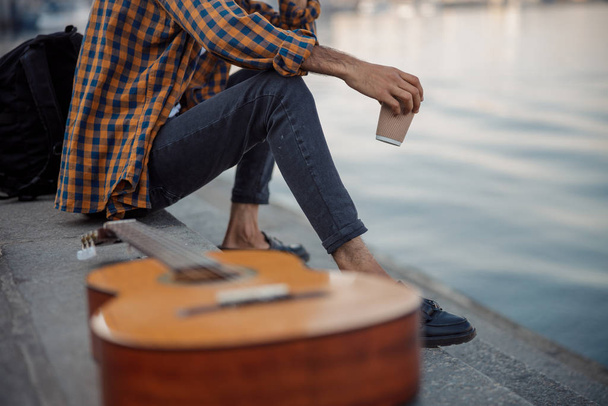 Guitarist is sitting with coffee and guitar - Foto, Bild