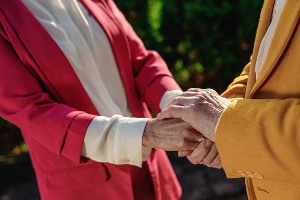 Elderly couple connecting hands outdoors stock photo - Foto, immagini