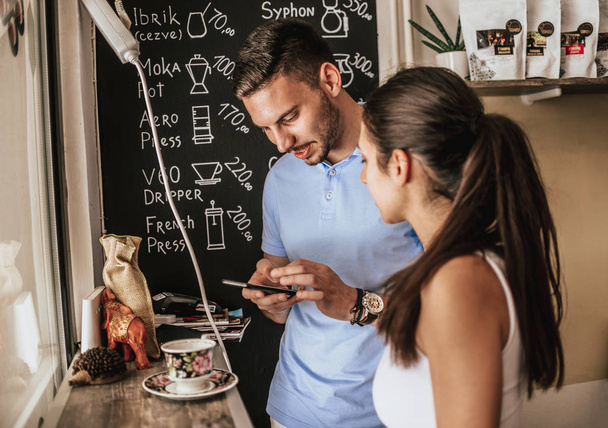 Zwei junge Erwachsene treffen in einem Café einige Entscheidungen - Foto, Bild