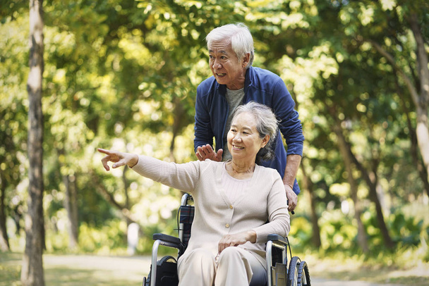 asian senior couple relaxing in park - Photo, Image