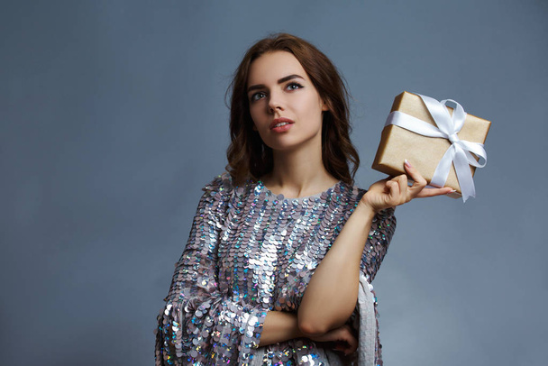 girl in shiny dress with gift box - Fotó, kép