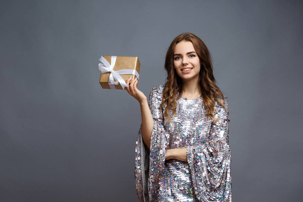 girl in shiny dress with gift box - Foto, Imagen