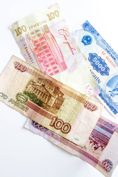 Russian, Ukrainian and Vietnamese money on a white background - Фото, изображение