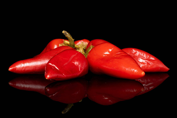 Hot pickled pepper isolated on black glass - Photo, Image
