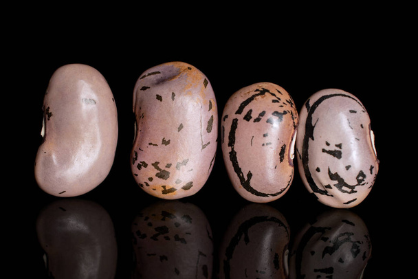 Pinto speckled bean isolated on black glass - Photo, Image
