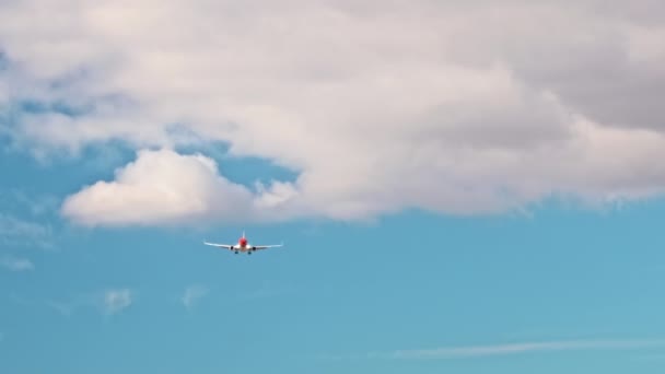 The red jet aircraft flies across the sky with the chassis released. Light clouds - Footage, Video
